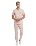 Pink scrub set with top and pants on a white background