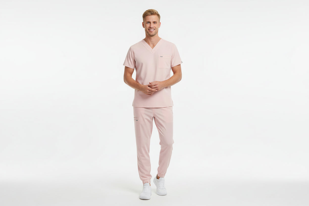Pink scrub set with top and pants on a white background