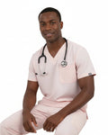 Man wearing a light pink scrub set on a white background
