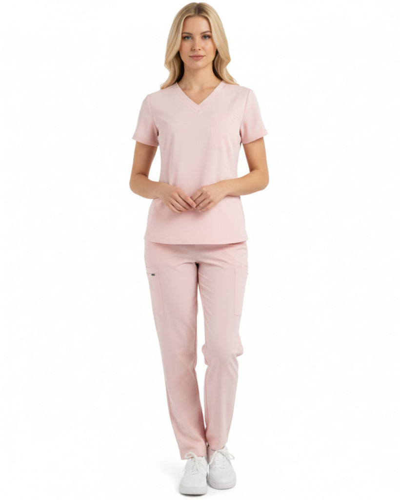 Female wearing a light pink pajama set on a white background
