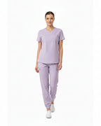 Lavender scrub set with top and pants on a white background