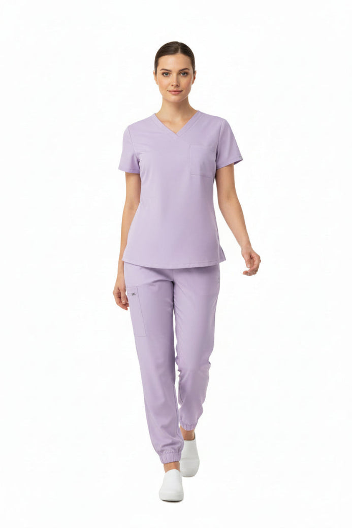 Lavender scrub set with top and pants on a white background
