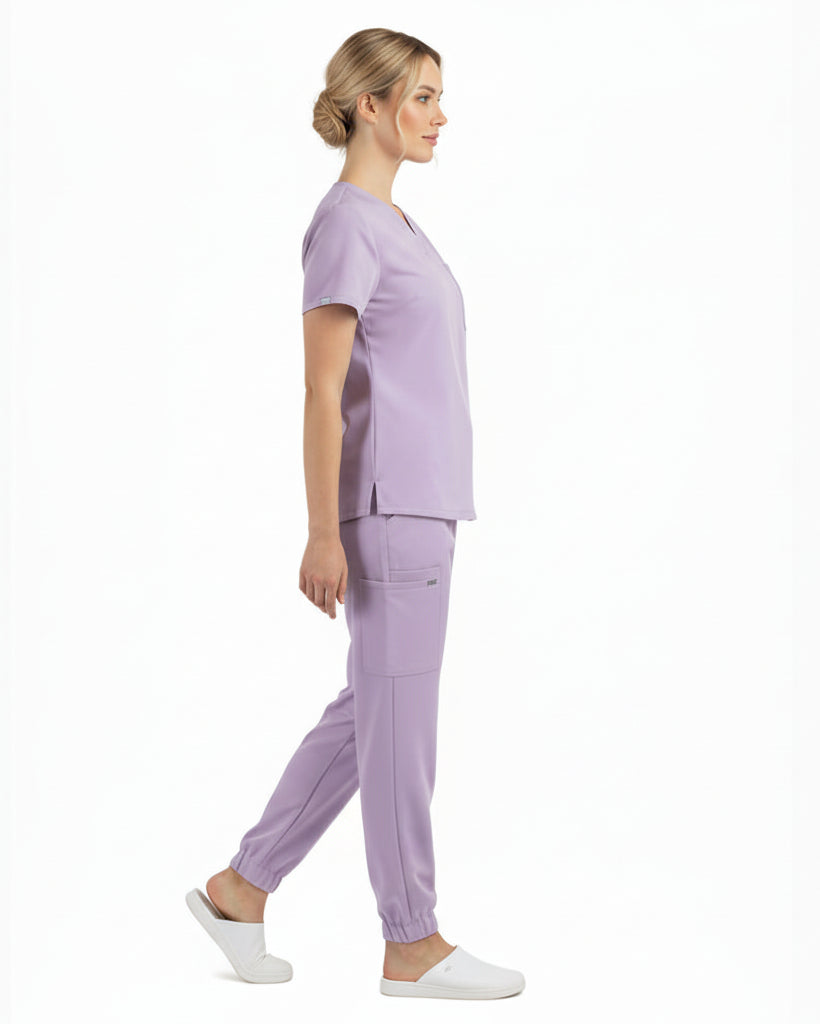 Lavender scrub set with top and pants on a white background