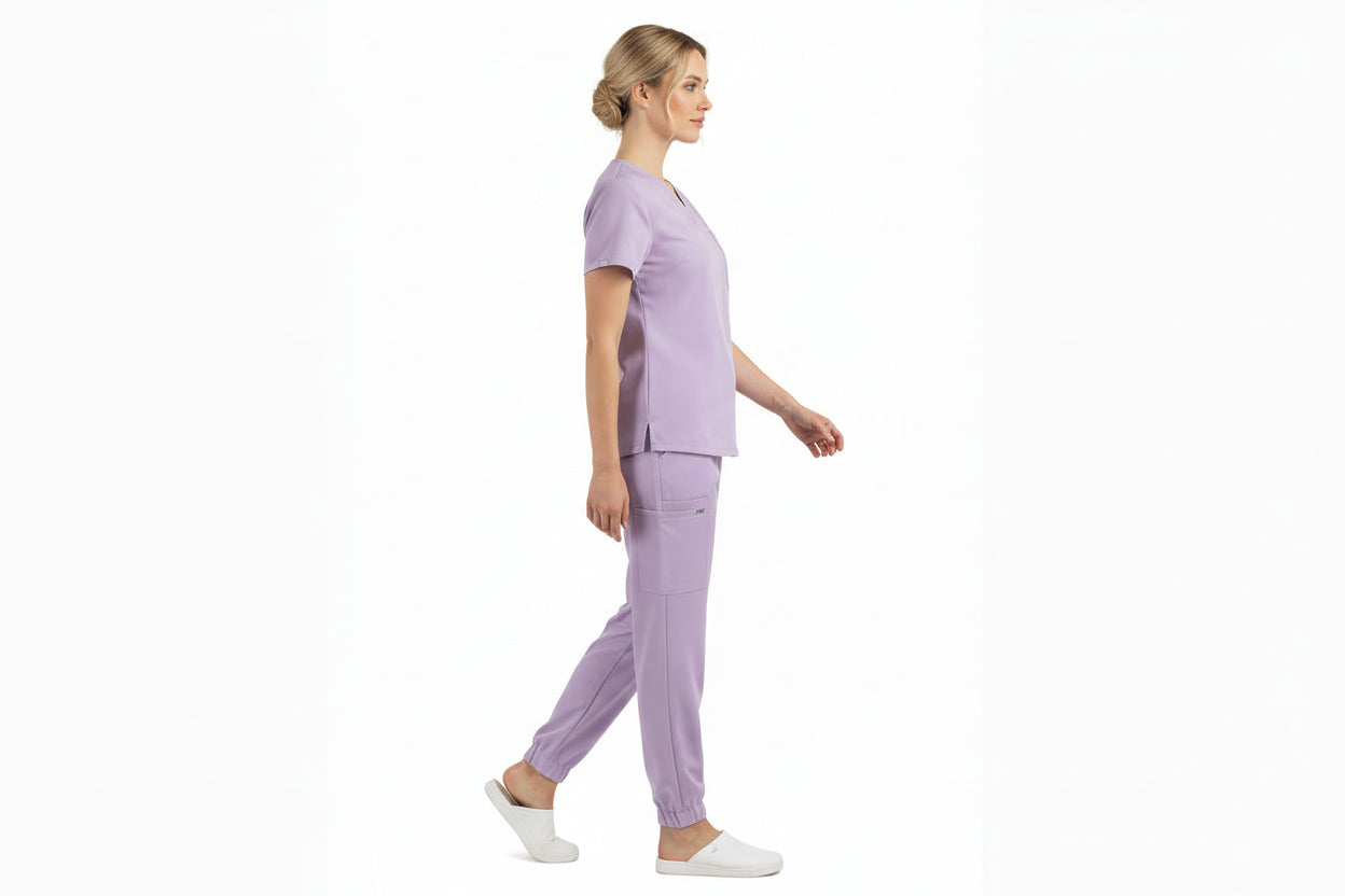Lavender scrub set with top and pants on a white background