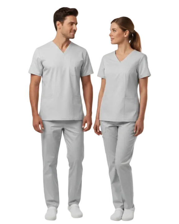 Man and woman wearing matching gray scrubs on a white background