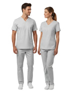 Man and woman wearing matching gray scrubs on a white background